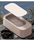 Buff That Bling Out Smooth With This Timed Ultrasonic Cleaner Delivering High Frequency Vibration For Legit Deep Cleaning Of Rings Watches Eyewear Tools Compact Clean As A Whistle Setup shown with open lid and nearby smartwatch.