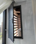 View of Badass Fire Rated Aluminum Access Panel With Integrated Locking Inspection Hatch and Sleek Black Shell open in wall.