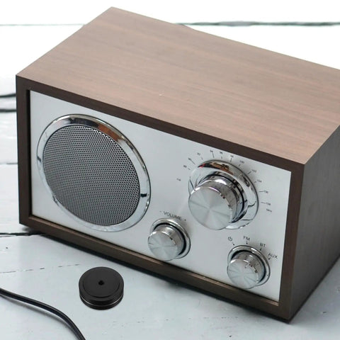 Aluminum Speaker Isolation Pads For Durable Vibration Control And Noise Reduction next to vintage speaker on table