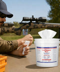 Man cleaning hands with 325 Count Lead Removal Wipes For Shooting Disposable Hand And Surface Cleaning Wipes bucket nearby