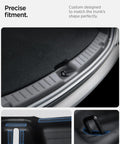 Spigen rear bumper trunk sill guard installed on Tesla Model Y 2025–2026, black with easy glide grooves
