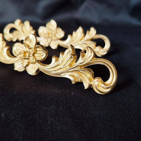 Solid Brass Double Hole Drawer Pulls In Vintage Style for cabinets and wardrobes with floral design on black fabric background