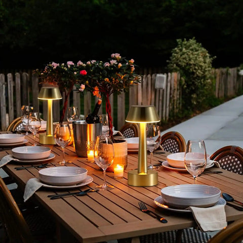 Outdoor dining table with cordless gold battery operated table lamps for dining ambience, rechargeable dimmable night light.