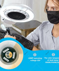 Technician using 80W Pro Grade Nail Dust Collector With Adjustable Suction And Built In Lighting, wearing mask and gloves.