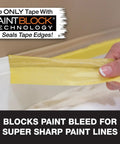 Hand applying Delicate Surface Painters Tape With PaintBlock Technology for sharp lines, low adhesion, 2 inch wide, yellow.