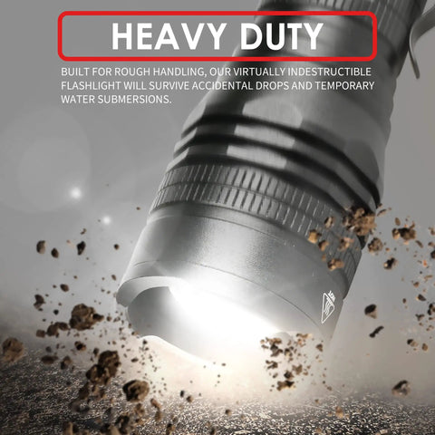 Close-up of LED Tactical Flashlight PTAC1000 emitting light, demonstrating heavy-duty build and durability against debris