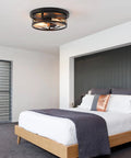 Black Flush Mount Ceiling Light Industrial Vintage Metal Cage Fixture in modern bedroom with wooden bed and grey decor.