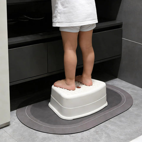 Heck Of A Sturdy Kids Step Stool With Super Grippy Non Slip Feet For Little Ones Reaching The Bathroom Sink Or Finishing Potty Training Without Any Wobbles, compact white stool in use.