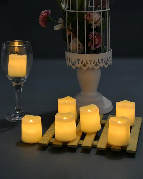 Flameless Votive Candles 24 Pack LED Tea Lights With Realistic Flicker, Battery Operated Warm White on table with decor