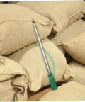 Stainless Steel Grain Sampler Tool With Handy Handle Compact Probe for corn, rice, and wheat sampling, resting on sacks