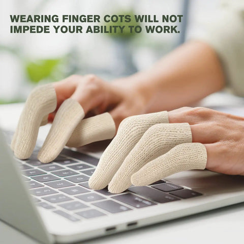 Hands typing on a laptop while wearing Cotton Finger Cots 20 Pack For Cracked Skin And Eczema Calluses Moisture Wicking Breathable Hand Protection For Men And Women Short Length Comfort Fit