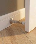Heavy Duty Door Stoppers For Bottom Of Door Solid Metal Baseboard Mounted Screw In Wall And Floor Protector Satin Nickel Finish 3 Inch 8 Pack close-up of door stopper in use