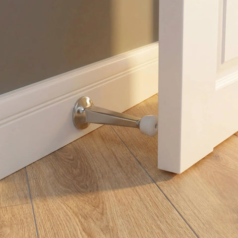 Heavy Duty Door Stoppers For Bottom Of Door Solid Metal Baseboard Mounted Screw In Wall And Floor Protector Satin Nickel Finish 3 Inch 8 Pack close-up of door stopper in use