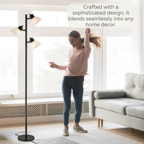 Three Light Black Floor Lamp Tree Style With Industrial Modern Look And Three Adjustable Heads For Ambient And Task Lighting A Tall Pole Lamp Built For Living Room Or Office And Ready To Shine Like A Boss in a living room setting with person enjoying atmosphere.