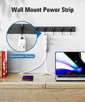 Wall-mounted white power strip with multiple outlets next to books and laptop, showing a convenient design.
