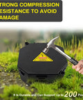Black Open Splice Junction Box 2 Pack With Cover showing compression resistance tested with hammer on grass.