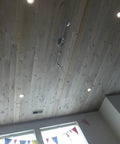 Slick Water Based Aging Wood Stain Yields Authentic Driftwood Gray Finish on a ceiling with recessed lights.