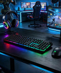 Dope Full Size Gaming Keyboard With Quick Turn Volume Knob, 104 Keys Wired PC Peripheral Featuring Fresh RGB Lighting And Crisp Feedback For Weekend Warriors on a gaming desk.