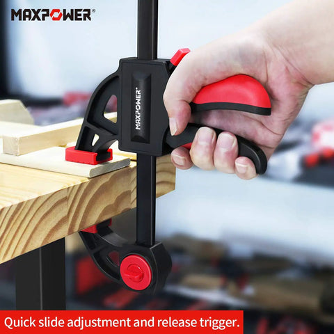 Close-up of hand operating 24 Inch Bar Clamp And 31 Inch Spreader Set for Woodworking Quick Release Clamps Pack Of 4 in use on wood