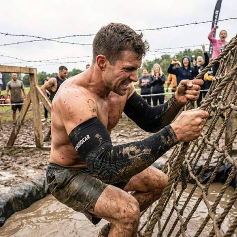 Man using Premium Padded Arm Sleeves with Compression Elbow Protection climbing muddy rope in obstacle race