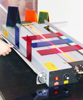 Rock Solid Electric Plastic Hot Bender And Acrylic Bending Press With Adjustable Heat Settings and Fast Chill Water Cooling, showing setup and colorful acrylic sheets.