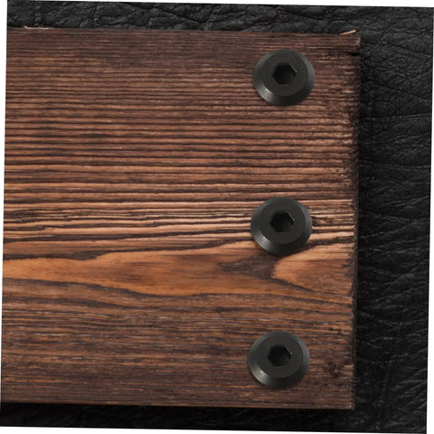 Badass Stainless Steel Chicago Binding Screws M6 X 25 Millimeter With Secure Cap Nuts in black on wood and leather surface