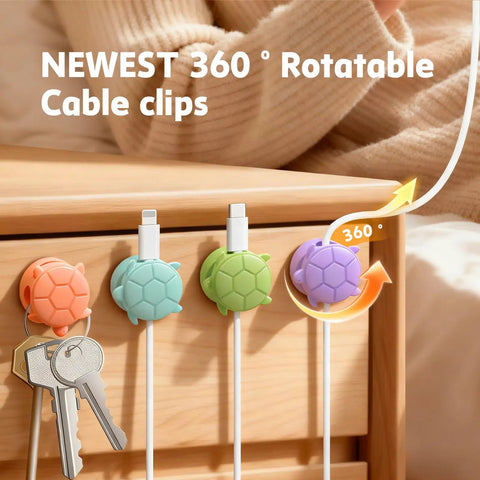8 Pack Rotatable Cable Clips For Desk, Nightstand, Car And Wall Mount, showing multicolor clips holding cables on a desk edge.