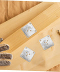 Rock Solid 25 Pack Furniture Leg Mounting Plates and Heavy-Duty Iron Brackets on wood with work gloves and pencil.