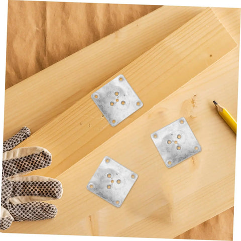 Rock Solid 25 Pack Furniture Leg Mounting Plates and Heavy-Duty Iron Brackets on wood with work gloves and pencil.