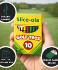 Hand holding Funny Golf Tees For Men 10 Pack Bamboo Wooden Tees Lit Gift Set in hilarious parody packaging on golf course