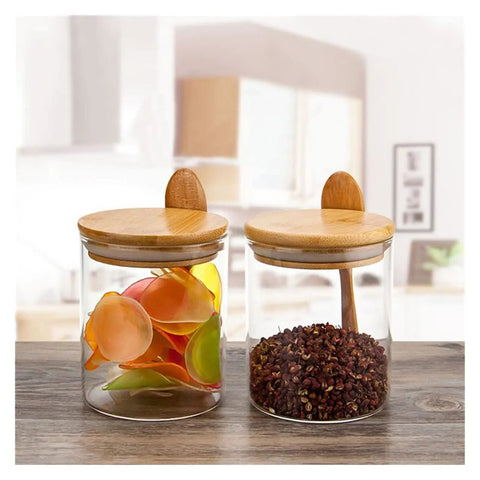 Keep Your Daily Grind Hella Fresh In This Rock Solid Clear Glass Coffee Canister And Airtight Food Storage Jar With Tightly Sealed Lid And Handy Spoon For Tea Sugar Salt Organization. Two glass jars with bamboo lids containing colorful items and spices.