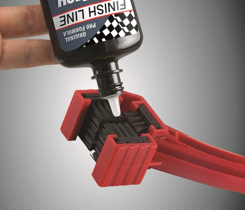 Applying lubricant on Grunge Brush Bike Chain And Gear Cleaner With Dual Sided Bristles for chains and cassettes cleaning