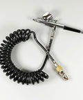 Heavy Duty Air Compressor Hose With 1 4 Inch Quick Release Couplers No Kink Nonsense Tubing coiled with airbrush for easy use.