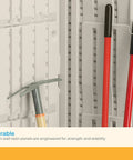 Interior of vertical outdoor storage shed with hooks holding long-handled tools, showcasing all-weather construction and stability.