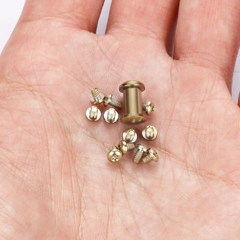 13-Piece Titanium Screw And Pivot Gear Kit For Bugout 535 Bailout 537 Mini Bugout 533 With Pivot Nut on a palm