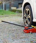 3 Ton Jack Handle Replacement For Horizontal Hydraulic Jack lifting a car wheel, heavy duty carbon steel build, non-slip grip.