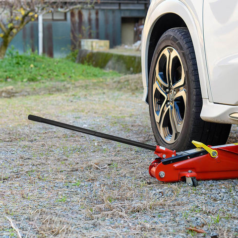 3 Ton Jack Handle Replacement For Horizontal Hydraulic Jack lifting a car wheel, heavy duty carbon steel build, non-slip grip.