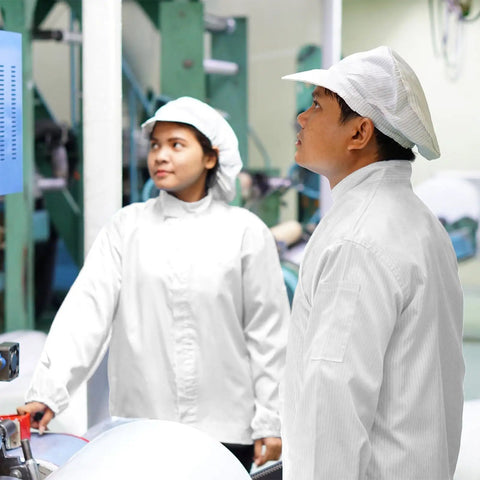Two people in ESD Anti Static Lab Coats With Protective Hood and Secure Cuff Design working in a high-tech environment.