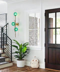 Dope Gold Long Strip 3 Light Globe Vanity Wall Sconce With Green Glass Shades Minimalist Mirror Bathroom Lighting Modern Contemporary Wall Fixture For Vanity And Mirror Area installed in hallway next to stairs.