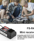 Flysky FS-R4B 2.4GHz 4CH Receiver With ANT Protocol And Single Antenna PWM Output next to people adjusting RC car outdoors
