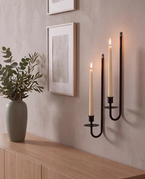 Built Tough Matte Black Farmhouse Wall Candle Sconce Holder Set of Two Heavy Duty Thick Iron Metal Wall Decor with Scratch Proof Finish for Warm Ambient Vibes, featuring two lit candles against a wall.