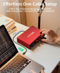 Person adjusting 2x2 24 Bit 192 KHz Audio Interface With XLR And TRS Combo Input Monitor Mix And Loopback USB C Plug And Play One Cable Setup For PC Mac And IOS Recording Alloy Red Finish next to a laptop.