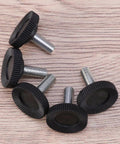 Badass Heavy Duty Adjustable Furniture Levelers With Tee Nuts Kits Black Steel And Rubber Pads For Killing Wobble On Cabinets Tables Chairs Workbenches Quick Setup close-up of black rubber pads with threaded steel screws.