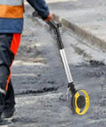 Jiawu Digital Display Distance Measuring Wheel Foldable Hand Push Roller Rangefinder measuring distance on asphalt surface.