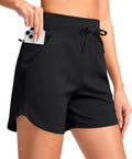 Woman wearing Women's 5 Inch Athletic Running Shorts With Quick-Dry Stretch, High Waist, 3 Pockets, inserting phone in zip pocket