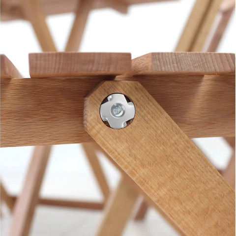 Close-up of Heavy Hitting 1/4-20 T Nuts Twenty Five Pack, Top Notch 304 Stainless Steel four jaw tee fastener on wooden furniture.