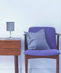 Mini Chrome Base Table Lamp With Fabric Shade In Periwinkle Purple on wooden table next to purple chair, modern decor.