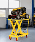 GarveeTech hydraulic lift table cart, yellow scissor-lift on wheels, carrying a lawn mower.