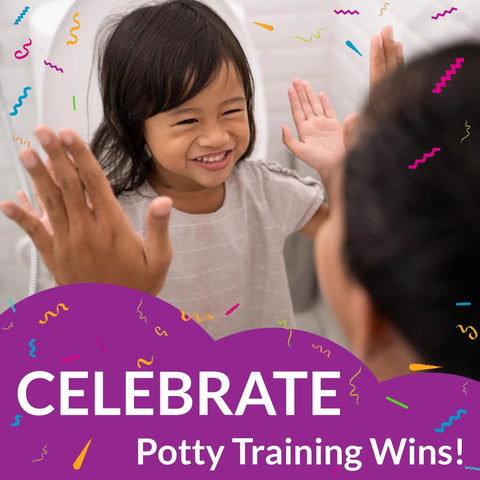 Child smiling in bathroom celebrating potty training success, against backdrop of elongated white toilet seat with built in potty training seat slow close removable that never loosens magnetic lid stow potty for kids 2 pack easy adult to kid transition space saving bathroom accessory.