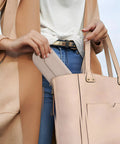 Silicone Makeup Brush Holder Travel Cosmetic Bag With Magnetic Closure Soft Portable Case being put in a purse